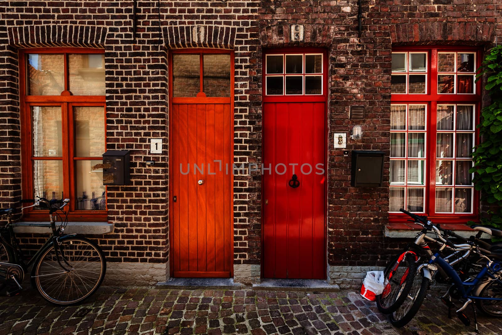 Doors of old houses and bicycles in european city. Bruges (Brugge), Belgium