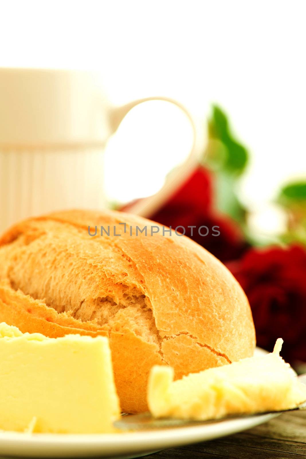 Bread butter and roses on wooden table - romantic breakfast  composition