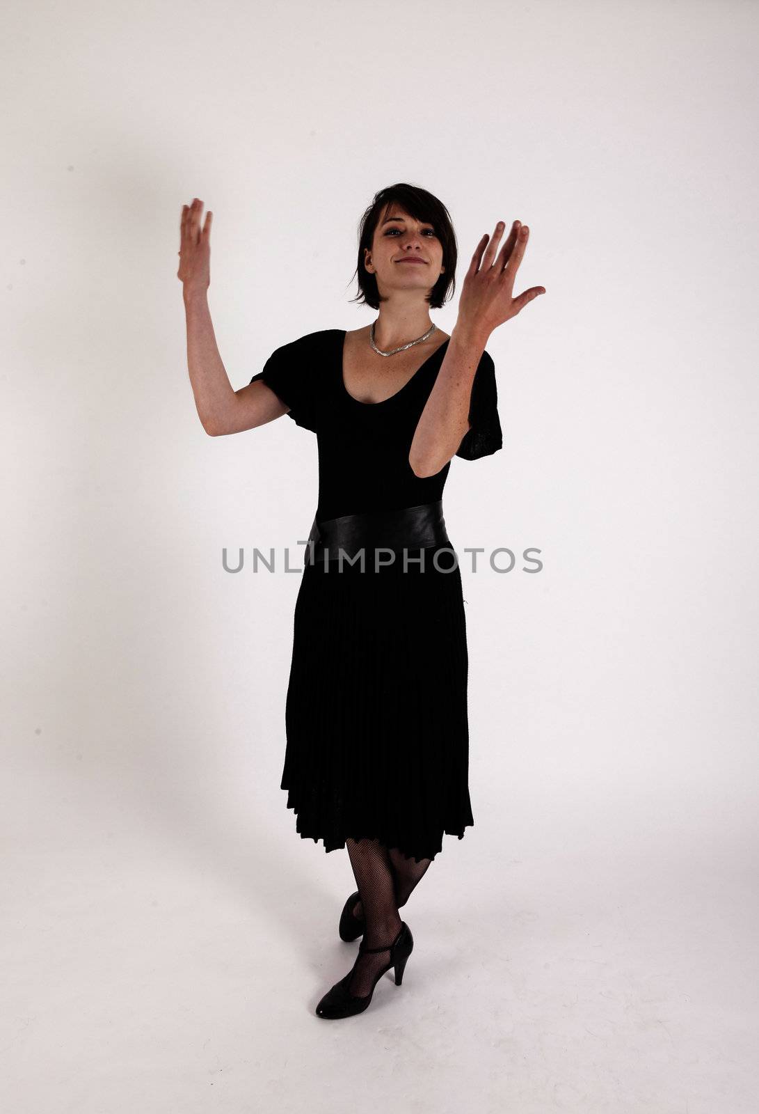 a young woman in strict black dress in studio looking like widow or nanny