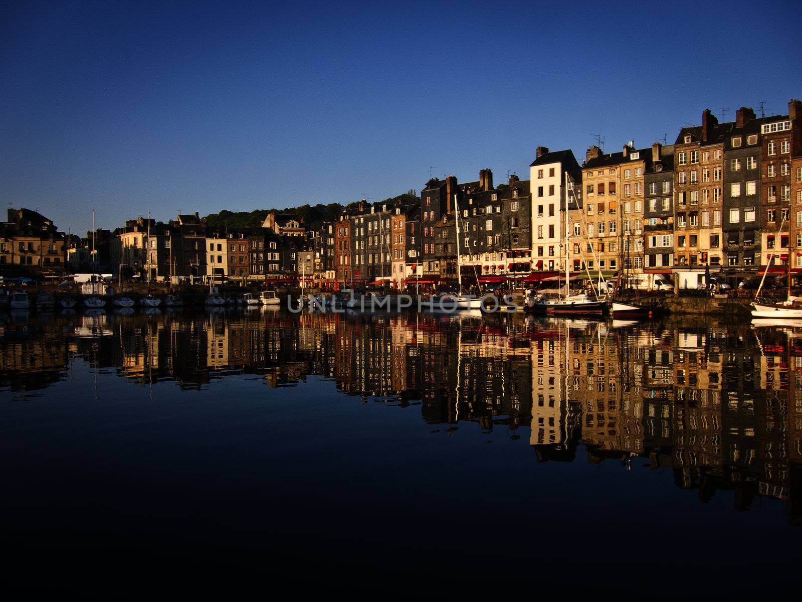 Honfleur harbour in France, in early morning light