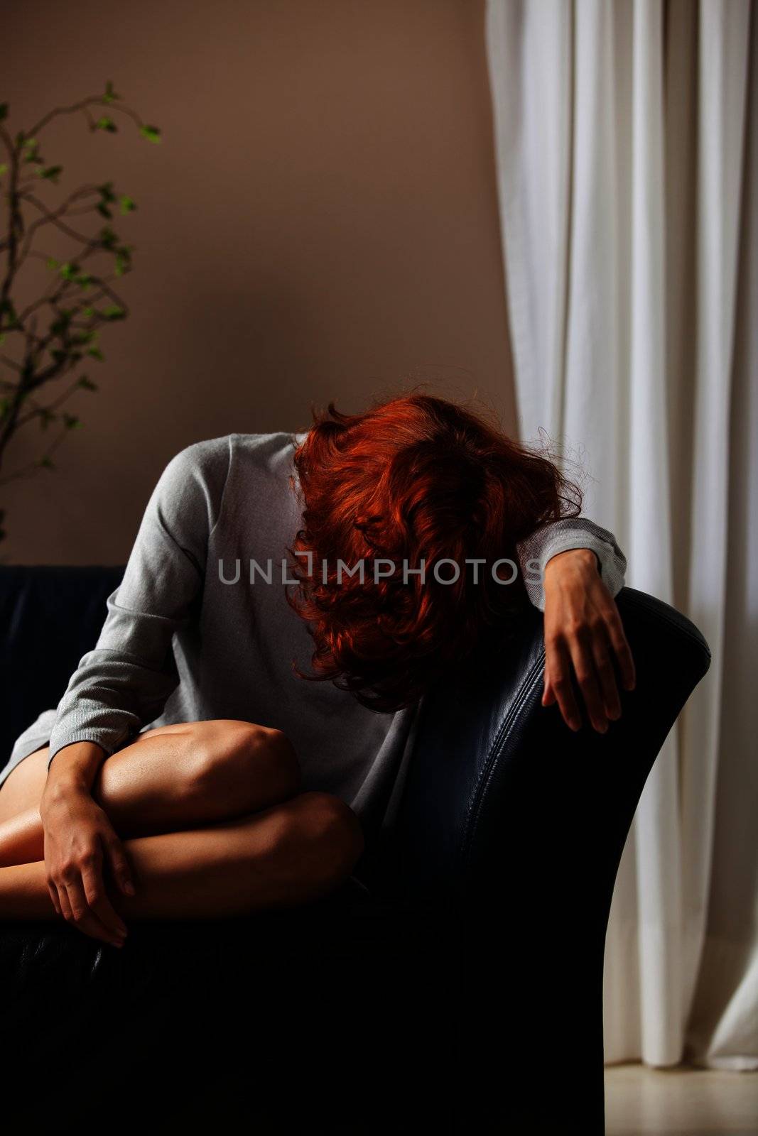 beautiful redhair depressed on a couch by bernjuer