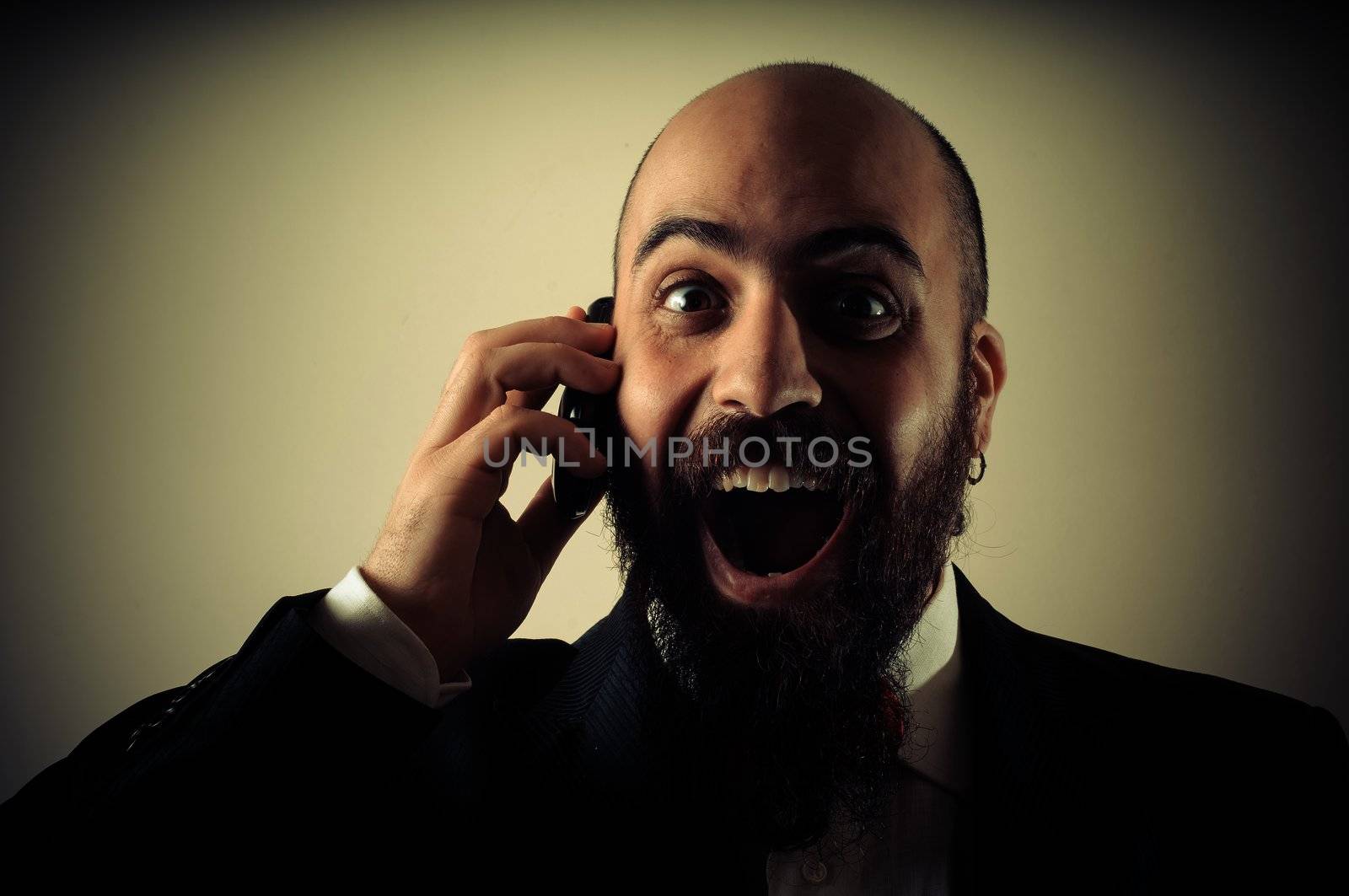  funny happy elegant bearded man on the phone on vignetting background
