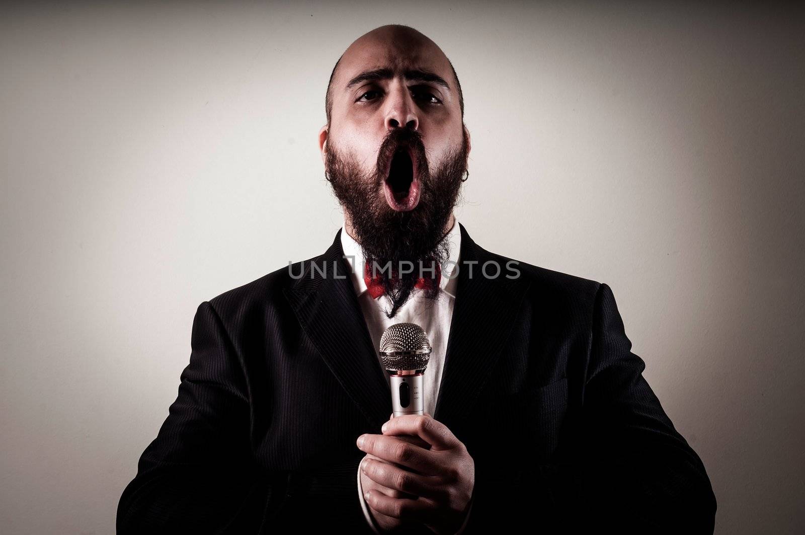  funny elegant singer bearded on vignetting background