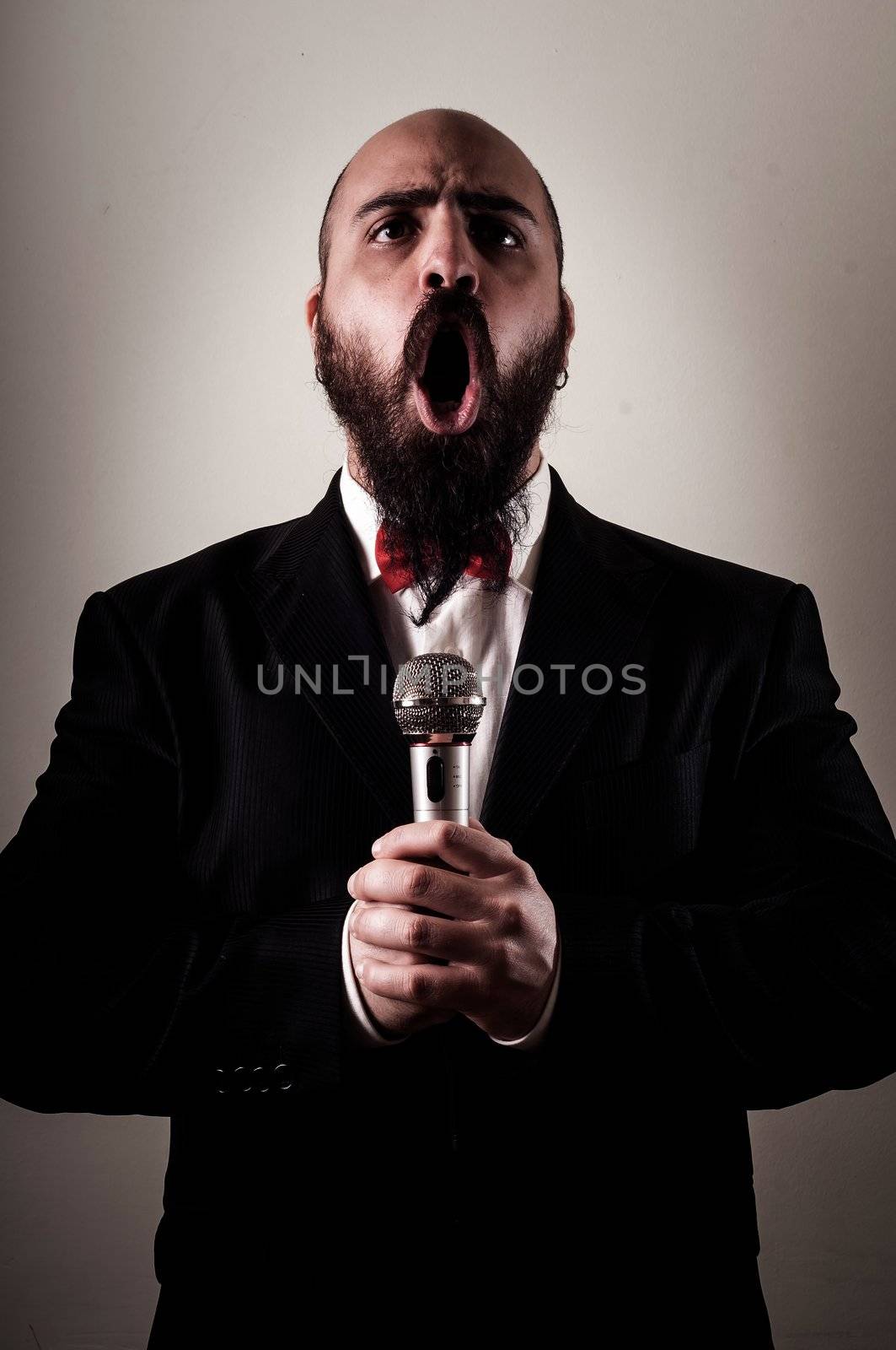  funny elegant singer bearded on vignetting background