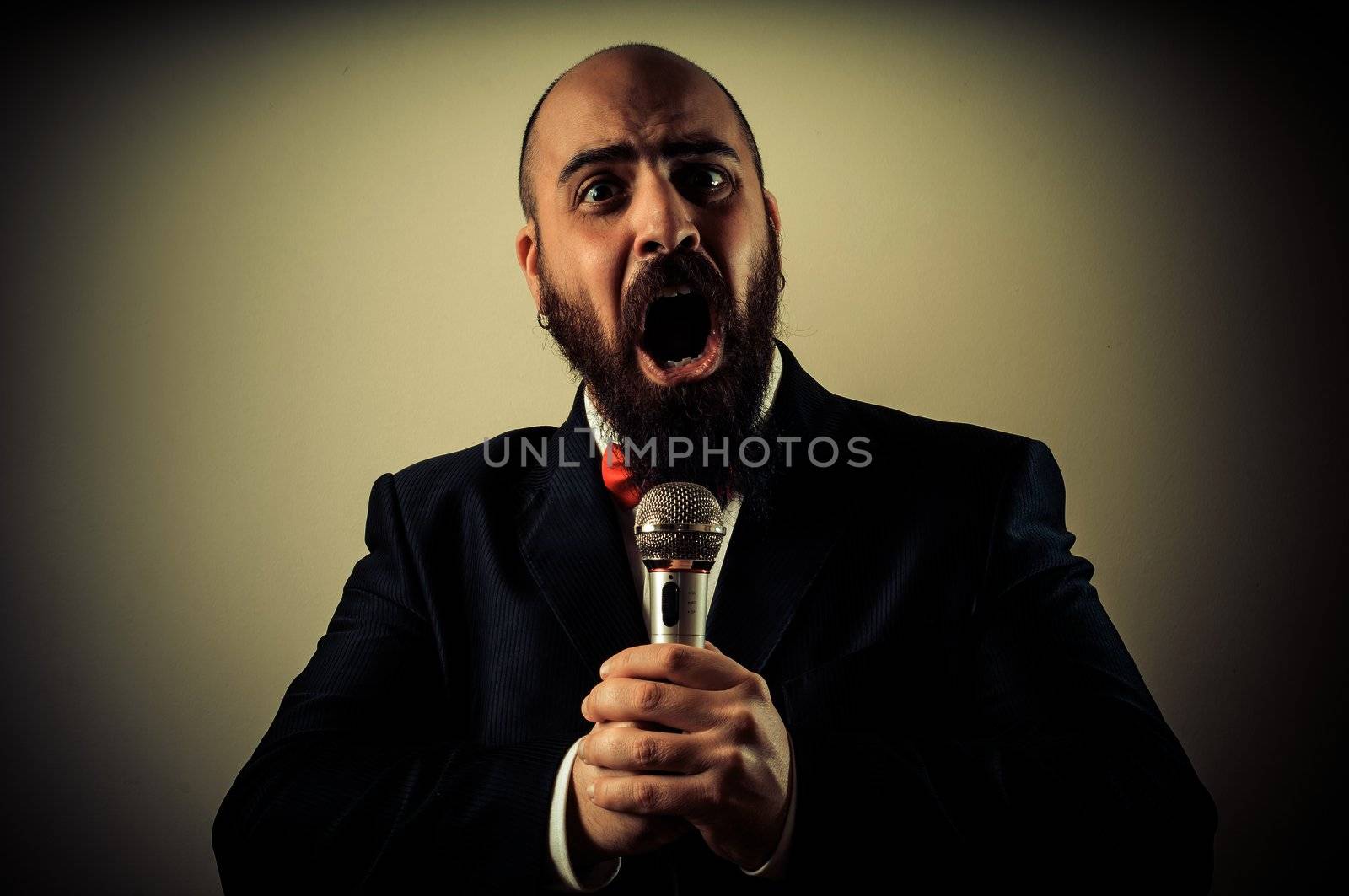  funny elegant singer bearded on vignetting background