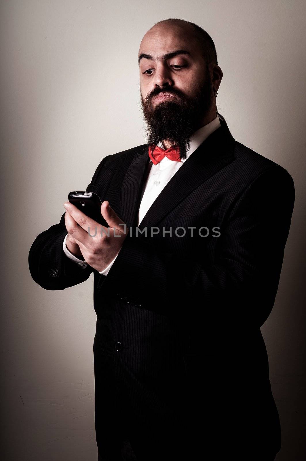  funny elegant bearded man on the phone on vignetting background