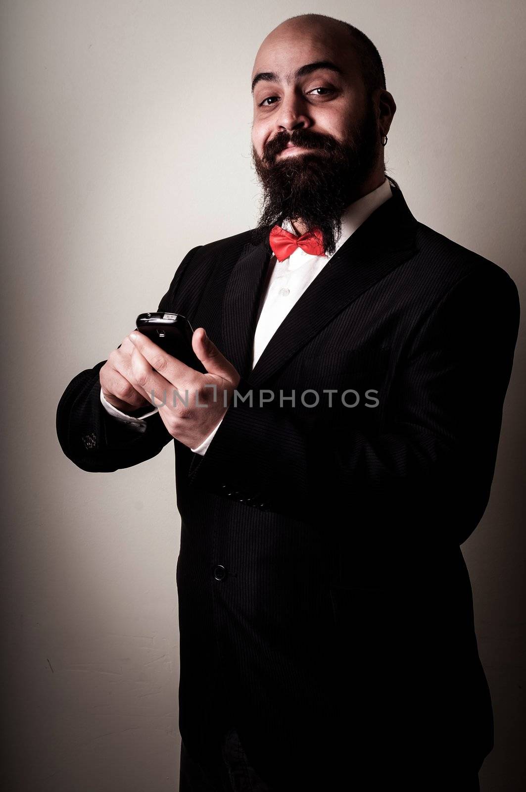  funny elegant bearded man on the phone on vignetting background