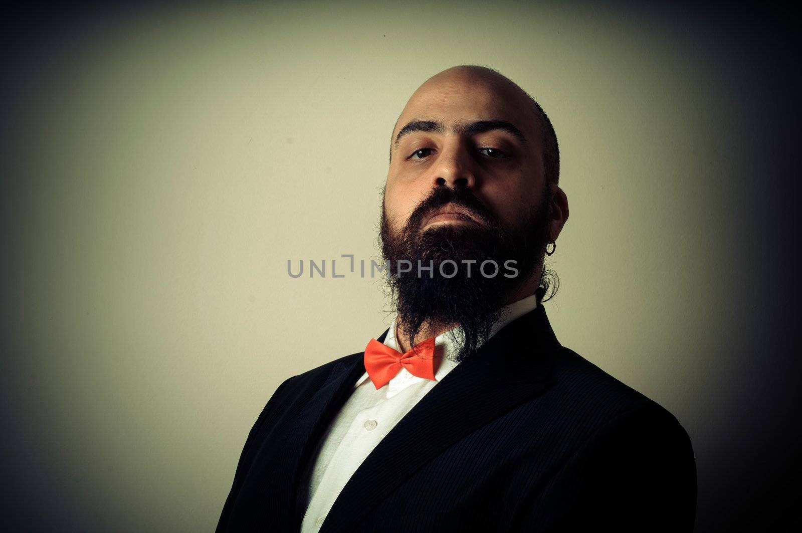  funny elegant bearded man on vignetting background