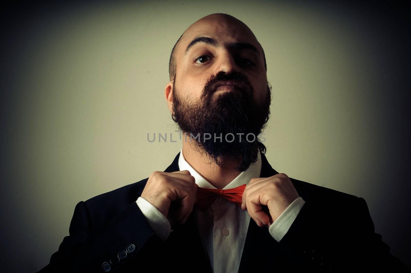  funny elegant bearded man on vignetting background