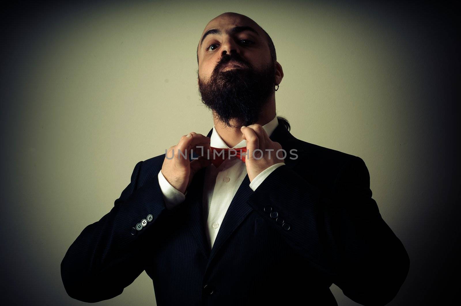  funny elegant bearded man on vignetting background