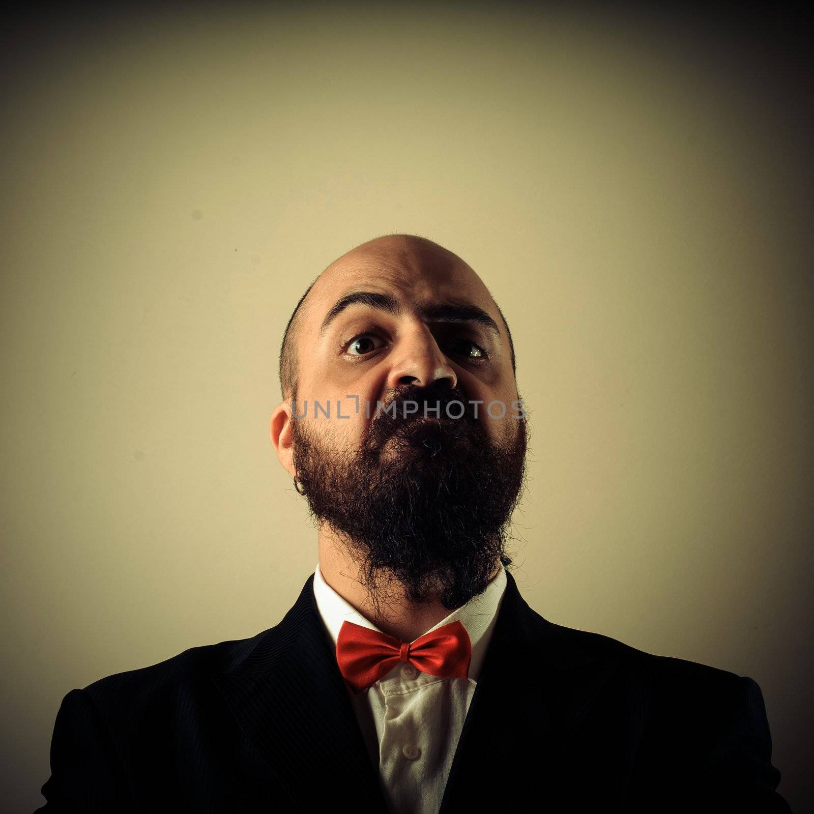  funny elegant bearded man on vignetting background