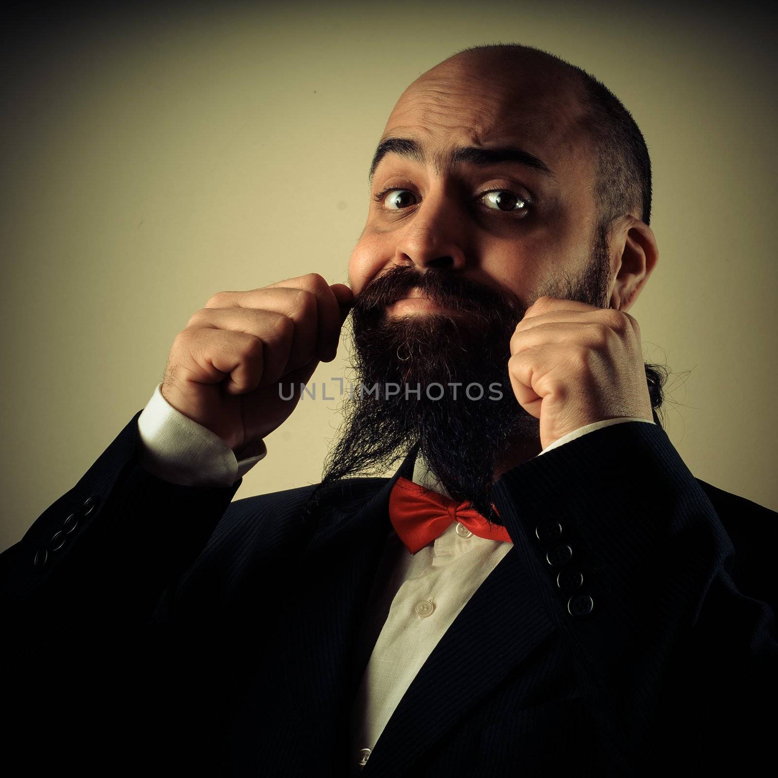 funny elegant bearded man touching mustache on vignetting background