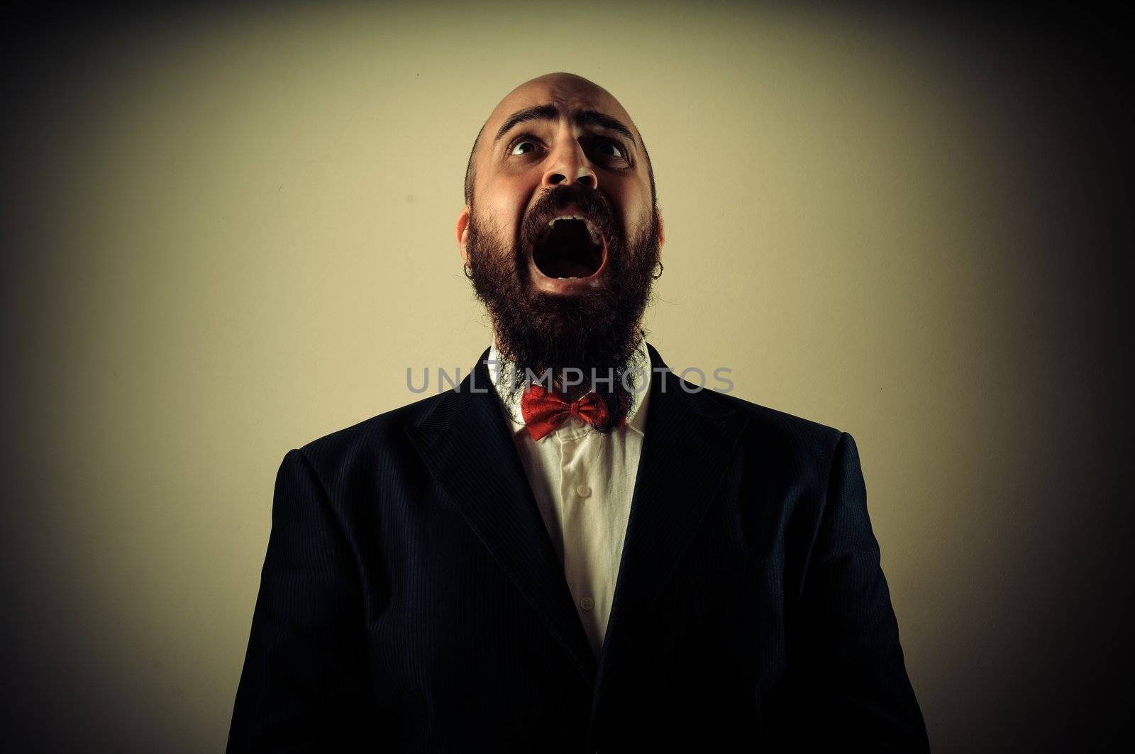 funny afraid elegant bearded man on vignetting background