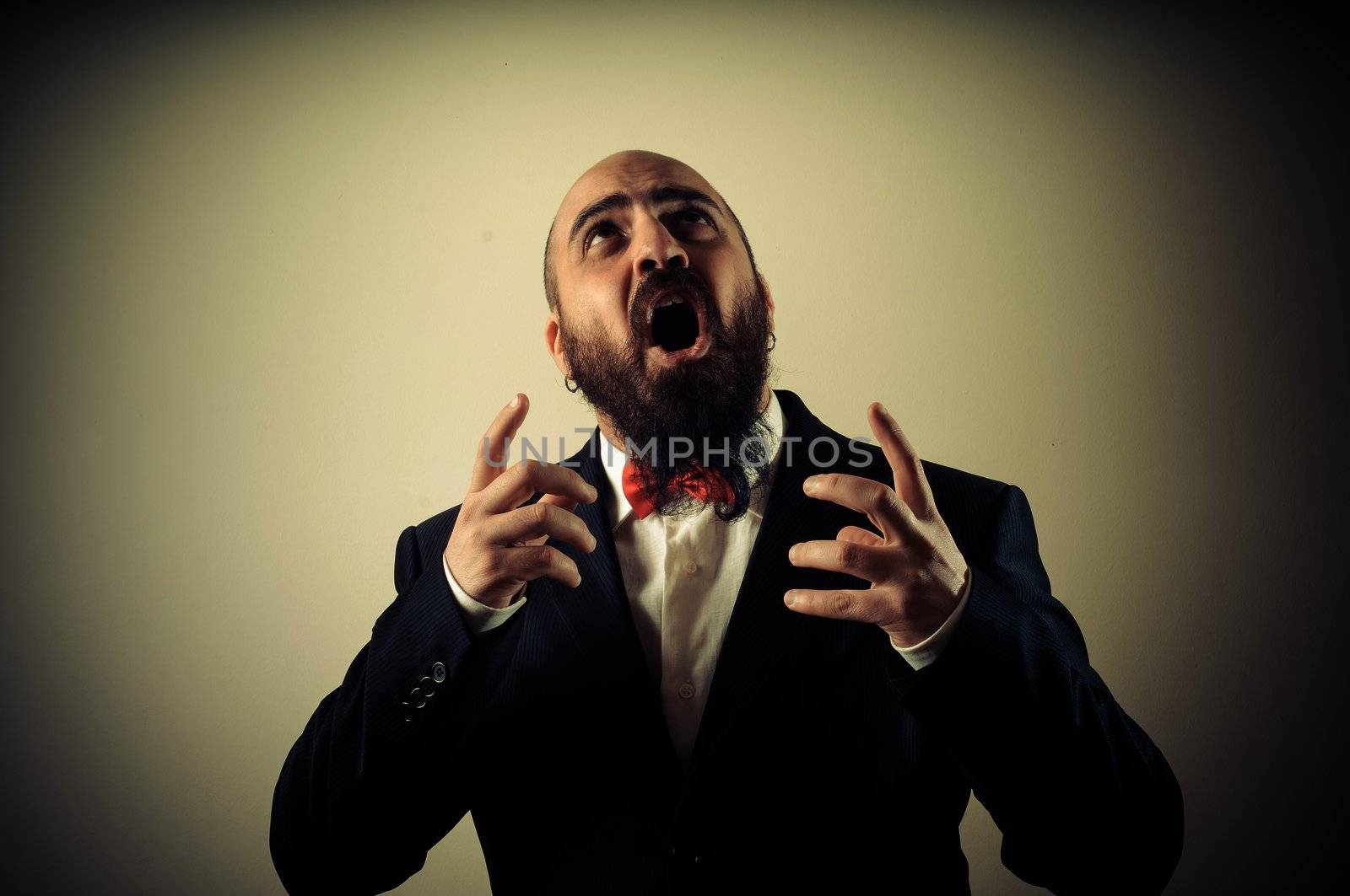 funny afraid elegant bearded man on vignetting background