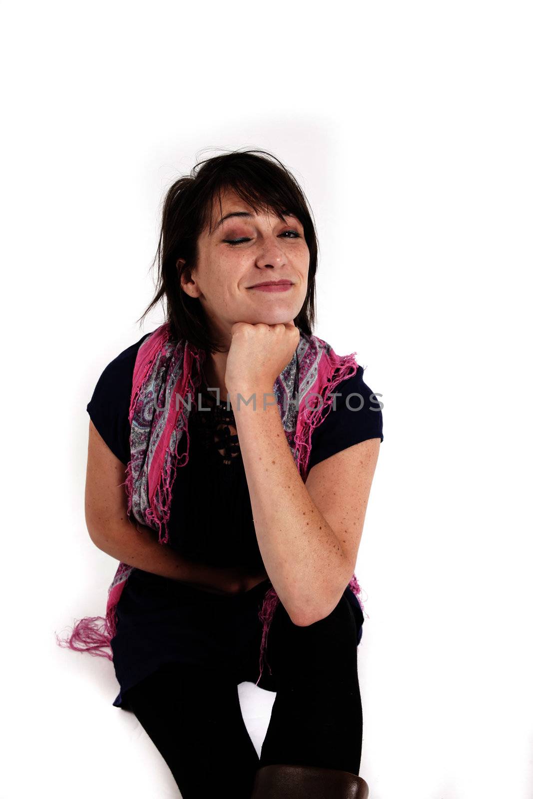 variation portrait of a young brunette woman with colored scraf on studio with her hand under her mounth