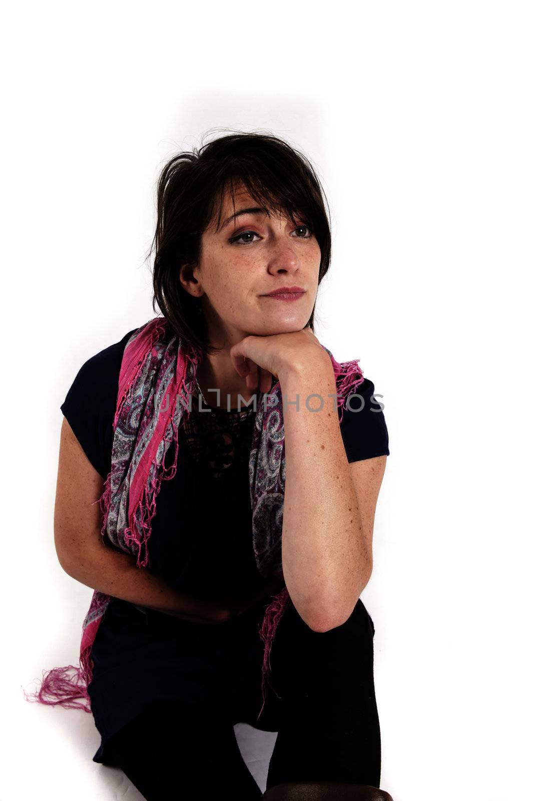 variation portrait of a young brunette woman with colored scraf on studio with her hand under her mounth