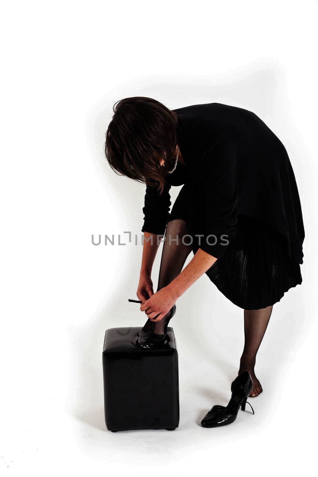 young brunette woman looking like a nanny or widow wearing a black shoe