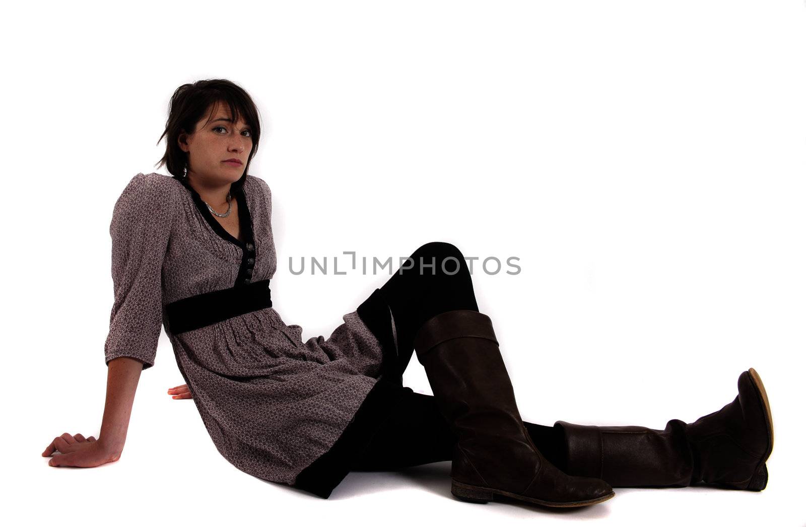 young woman sitting on the ground in boots by macintox