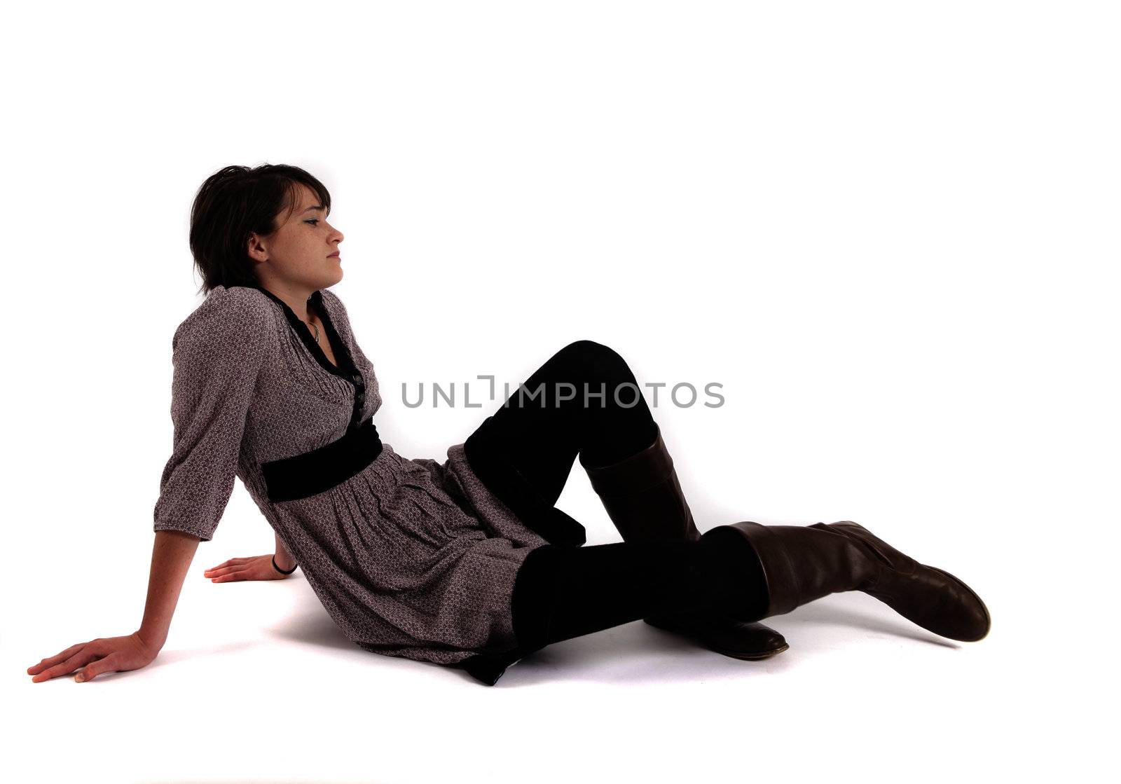 young woman sitting on the ground in boots by macintox