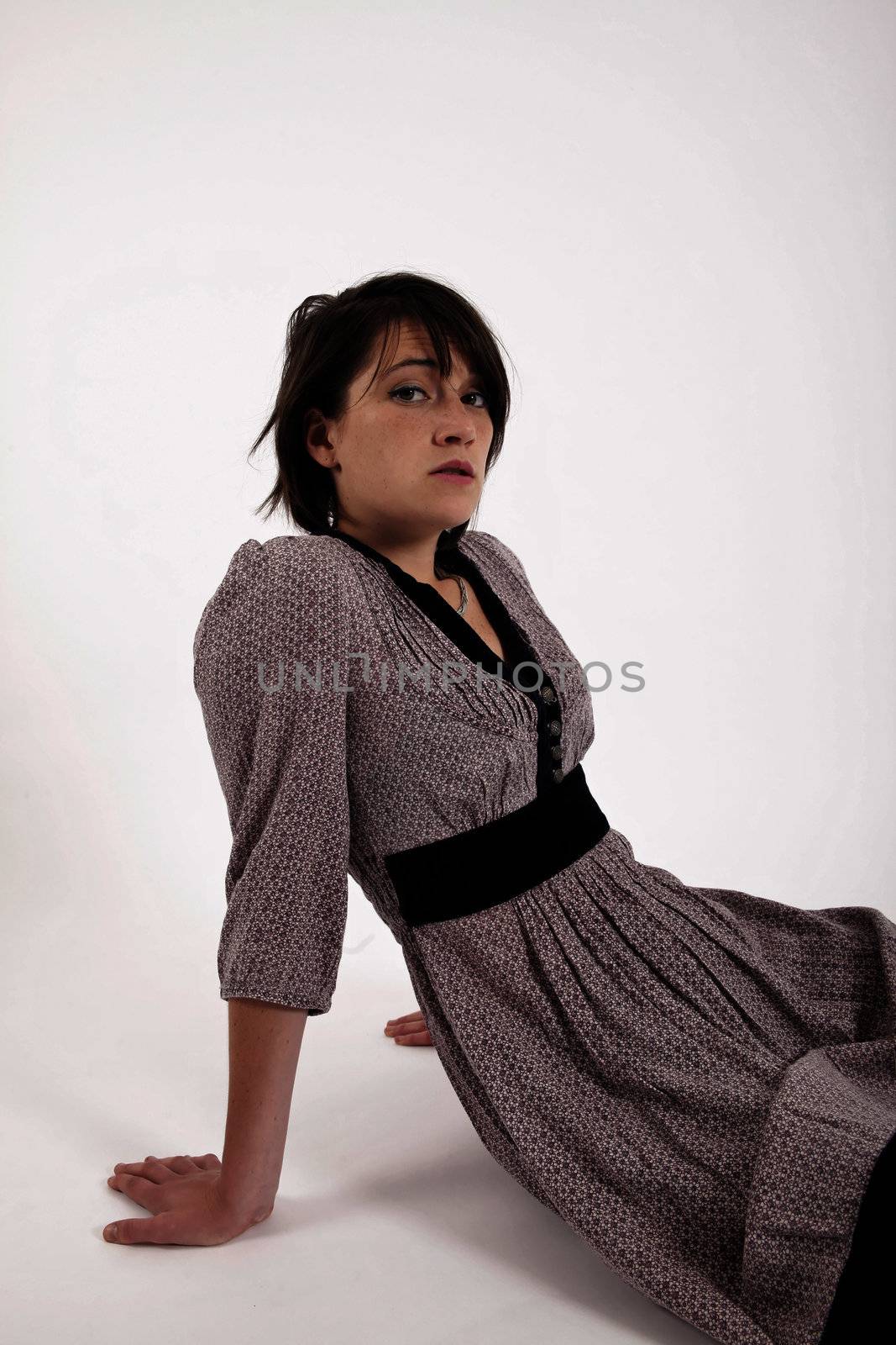 young woman sitting on the ground in boots by macintox