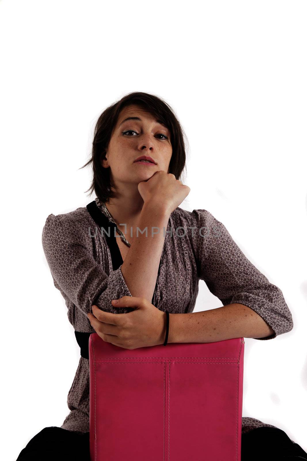 young woman looking ahead with hand under her face isolated in studio