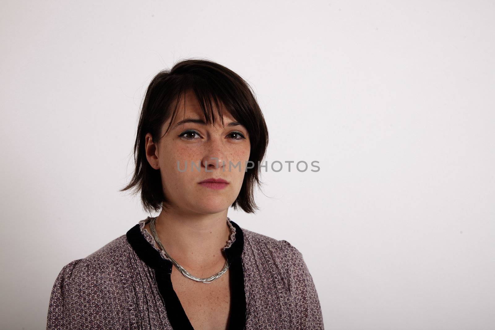 face of a young brunette woamn looking ostentatiuous isolated on studio