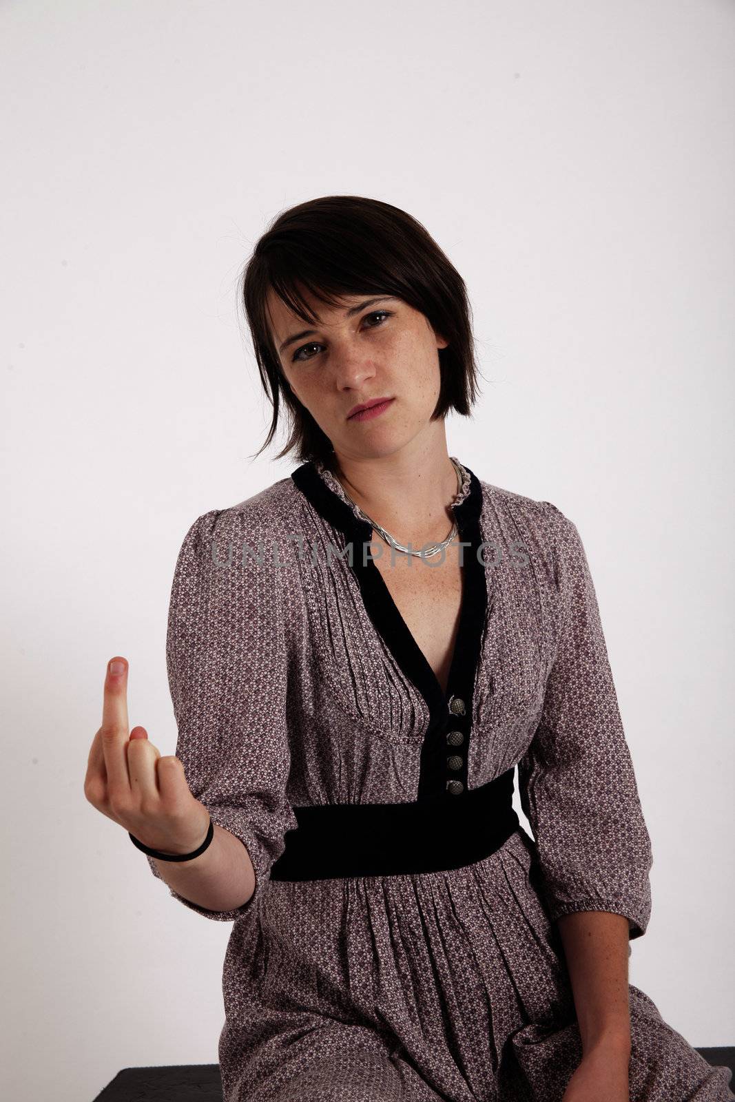 scornful young brunette woman on studio with her finger up