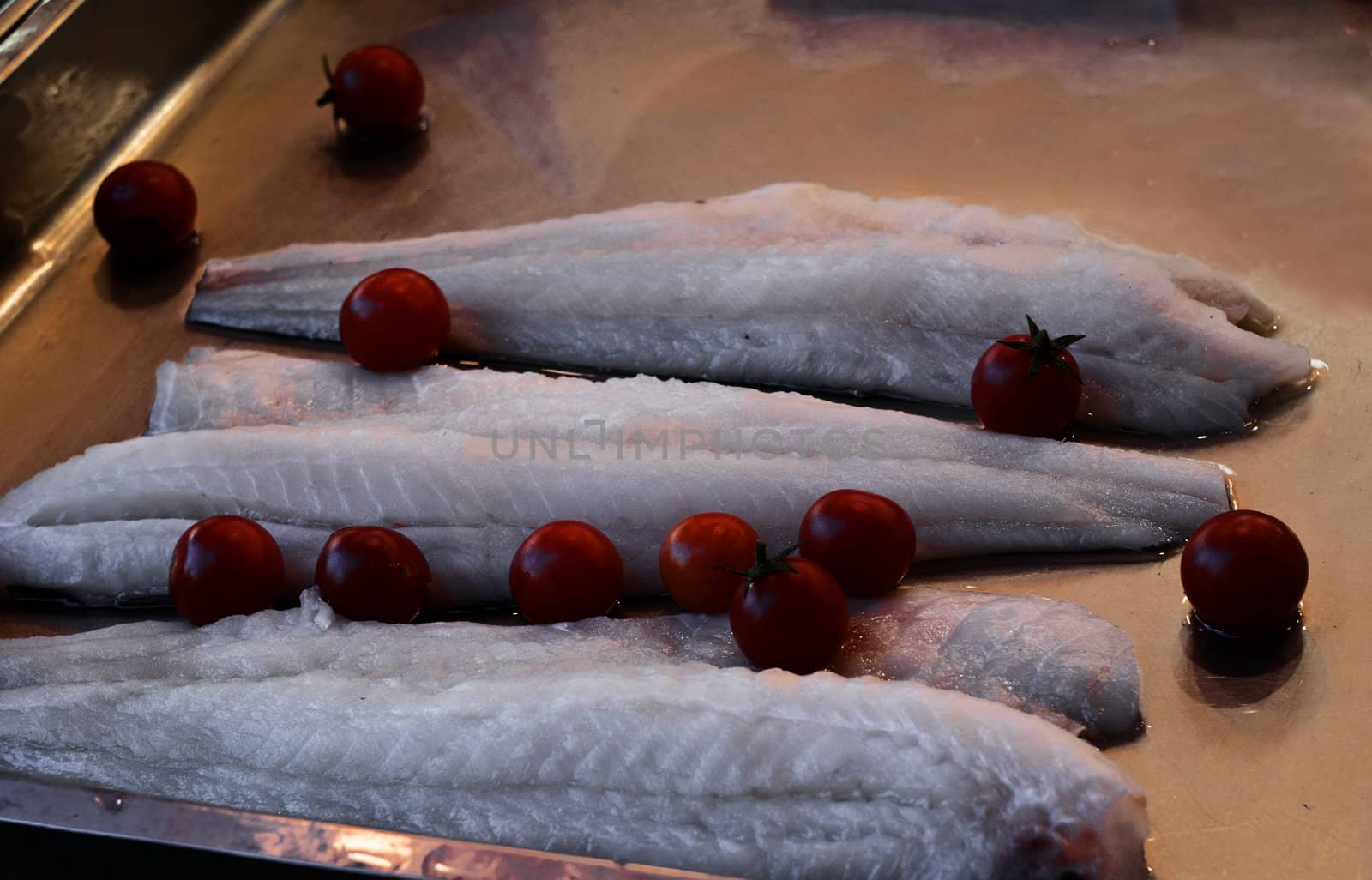 some pieces of fresh raw cod and tomatoes. Palermo, Sicily