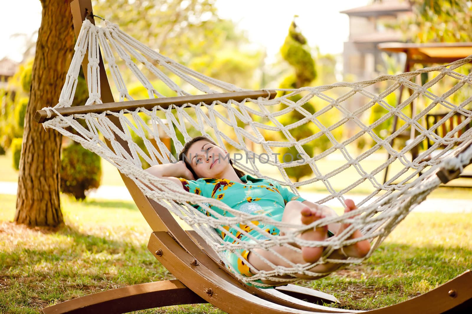 20-25 years woman portrait ralaxing on hammock at exotic surrounding