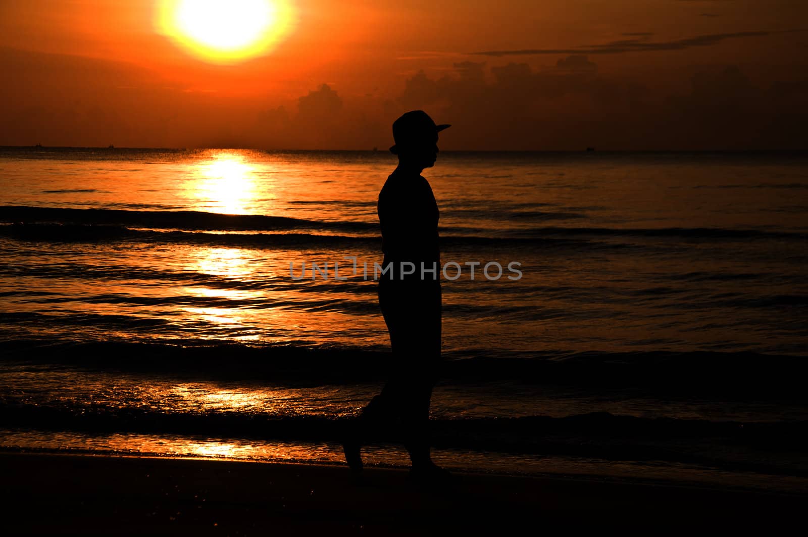 silhouette woman walking on the beach