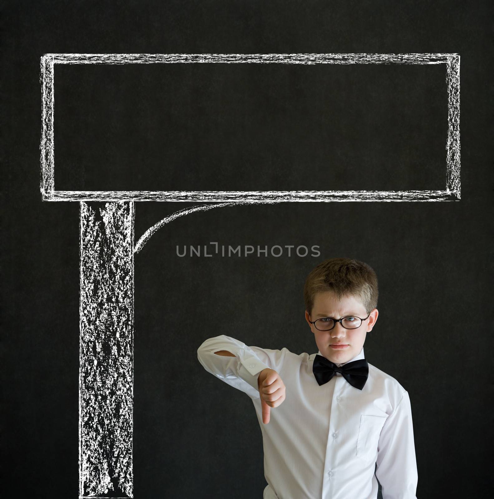 Thumbs down boy dressed up as business man with chalk road advertising sign on blackboard background