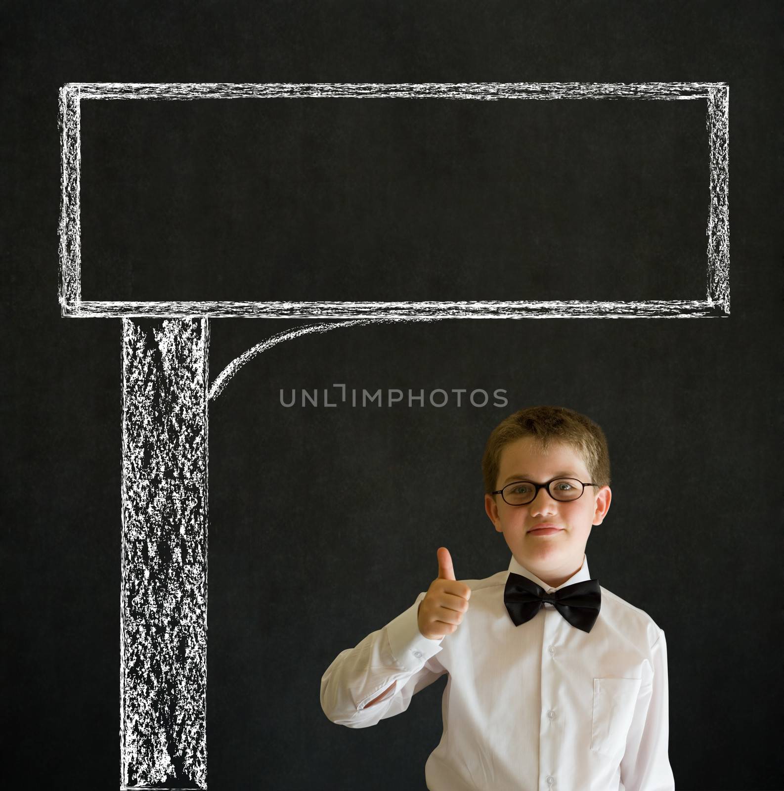 Thumbs up boy dressed up as business man with chalk road advertising sign on blackboard background