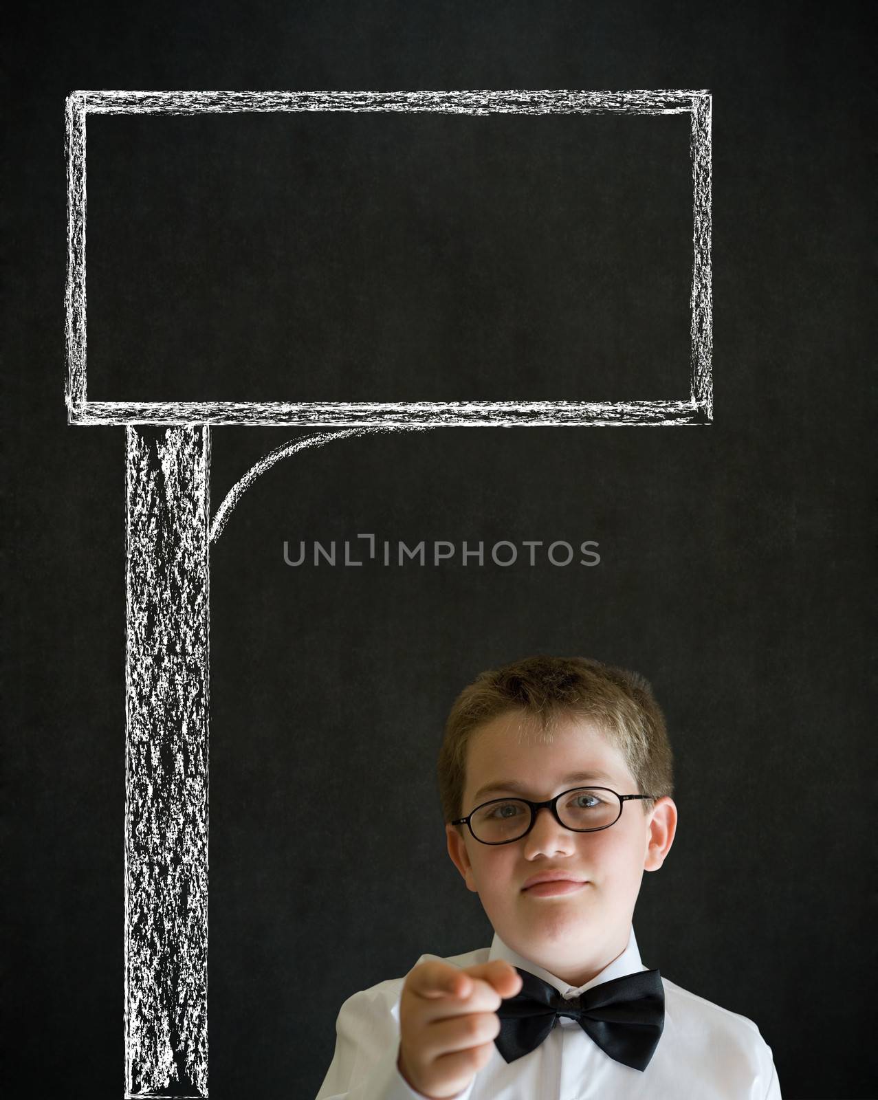Education needs you thinking boy dressed up as business man with chalk road advertising sign on blackboard background