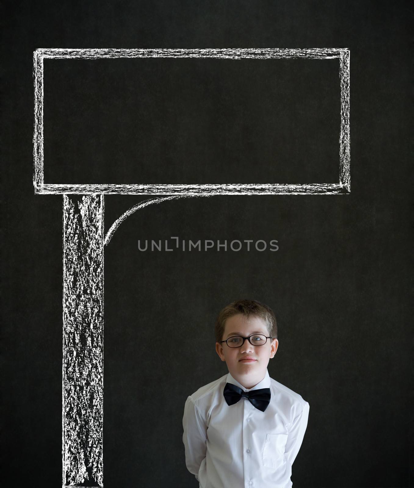 Thinking boy dressed up as business man with chalk road advertising sign on blackboard background