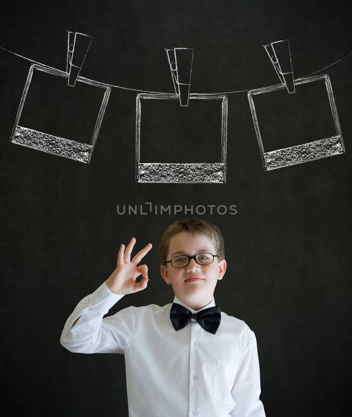 All ok boy business man with hanging instant photo photograph on clothes line by alistaircotton