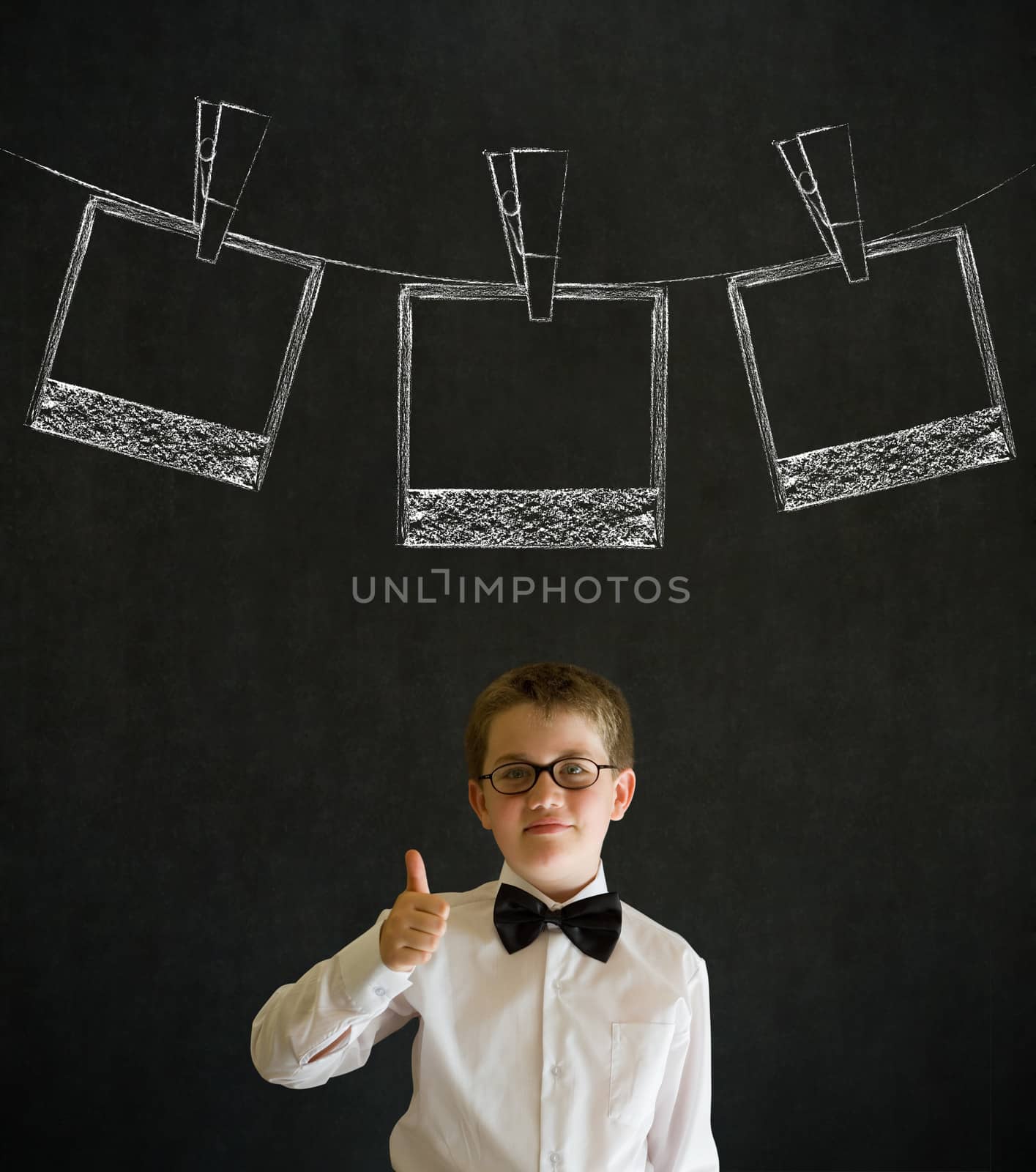 Thumbs up boy business man with hanging instant photo photograph on clothes line by alistaircotton