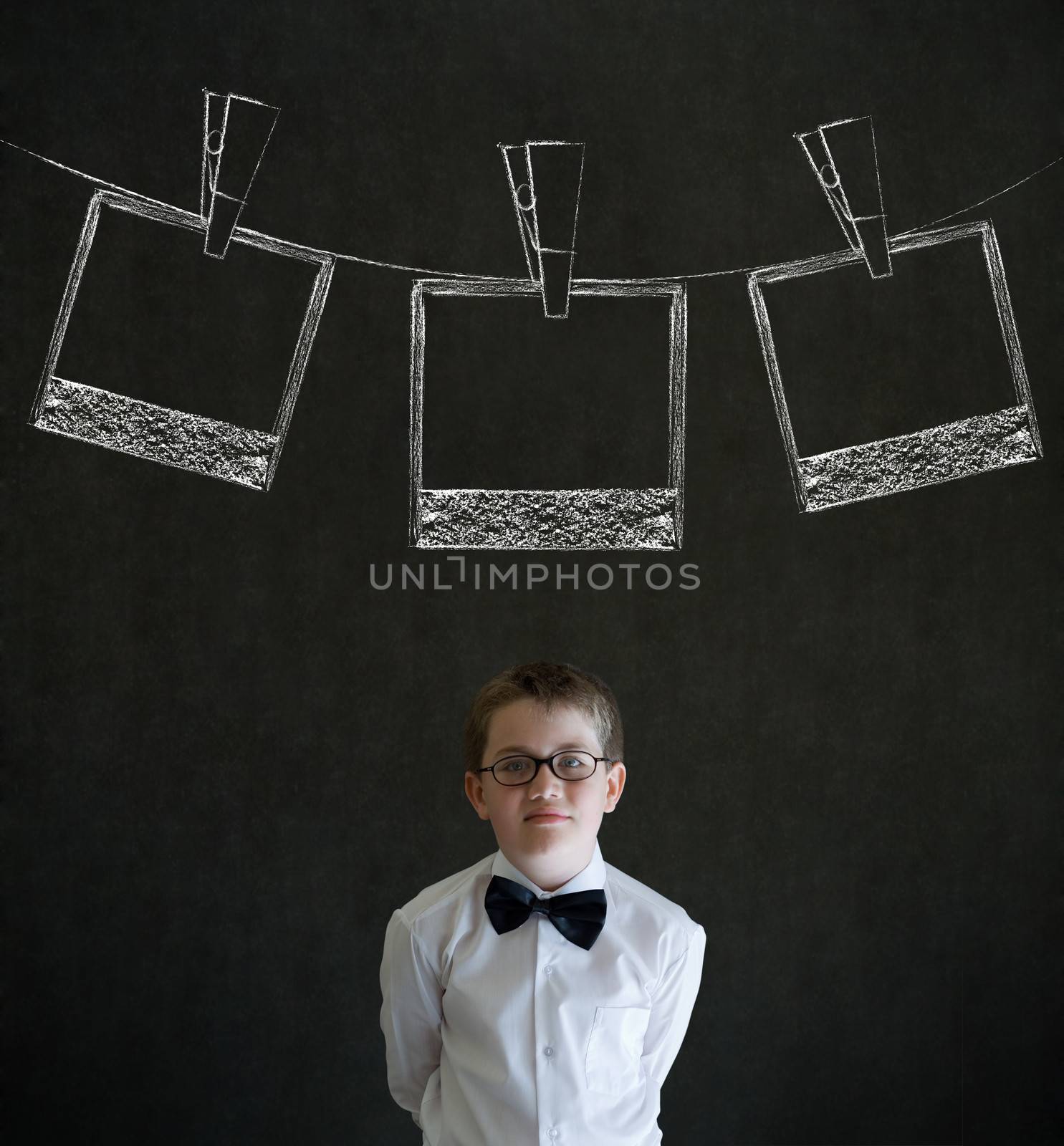 Thinking boy business man with hanging instant photo photograph on clothes line by alistaircotton