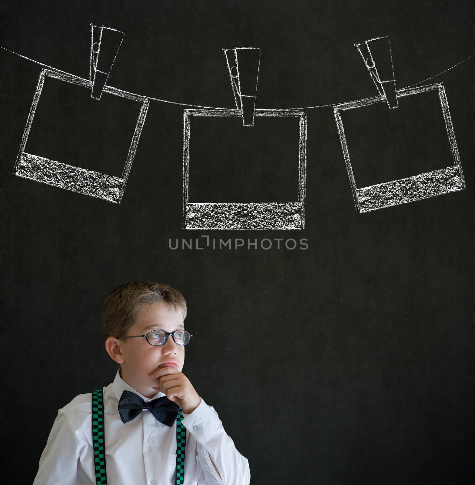 Thinking boy business man with hanging instant photo photograph on clothes line by alistaircotton