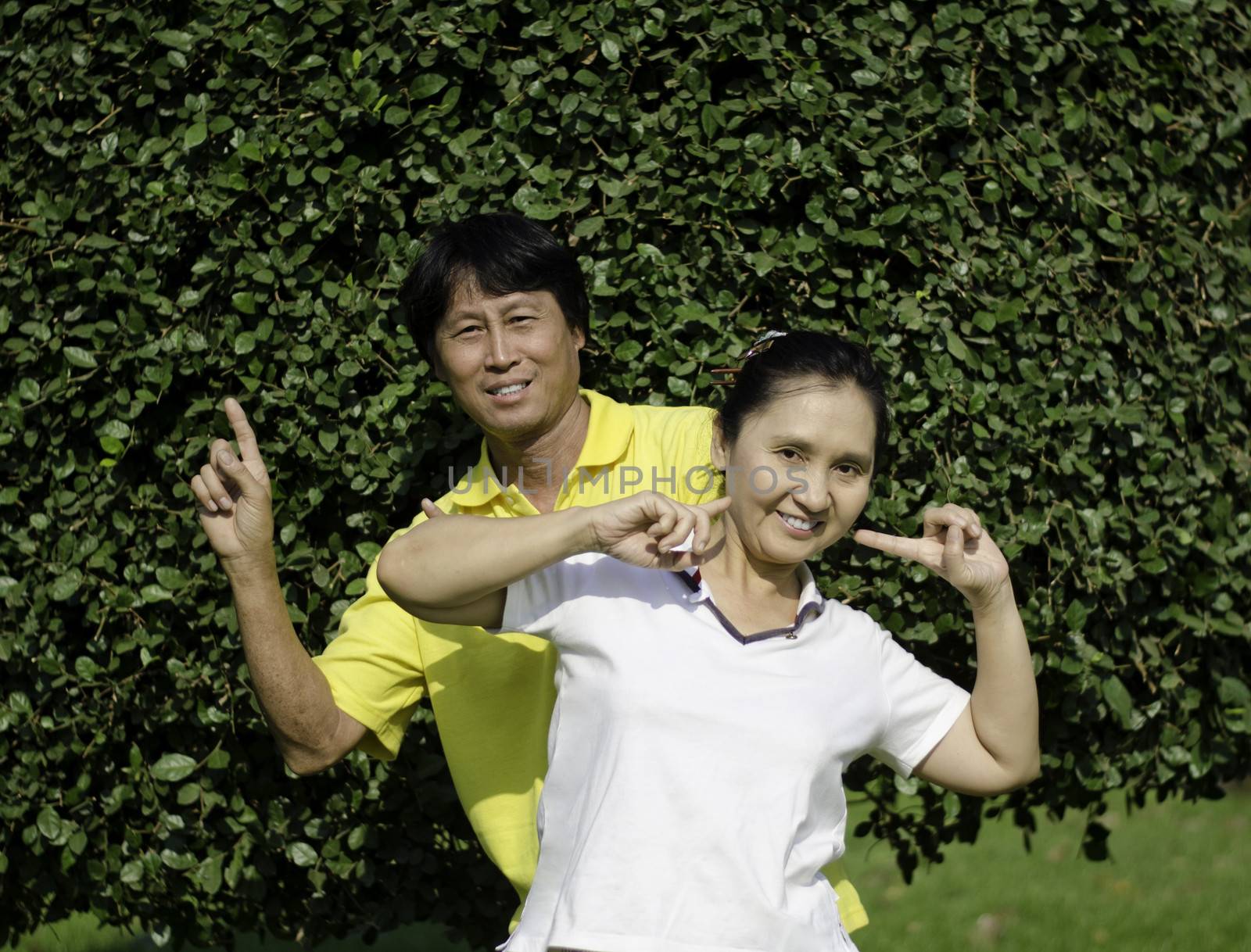 Portrait of beautiful couple relaxing in park relaxing 