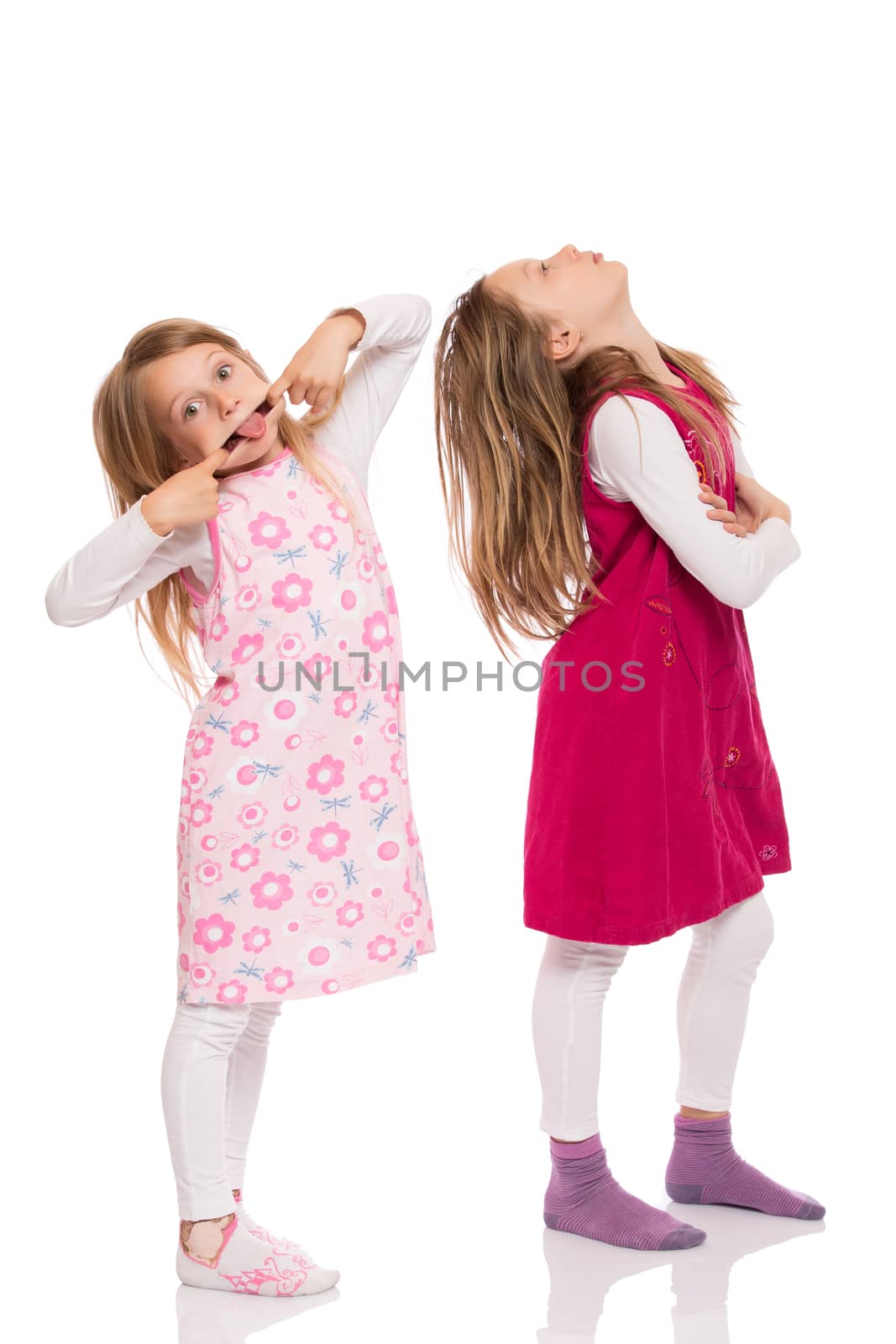 Two funny children with long hair making faces. Isolated on white background.