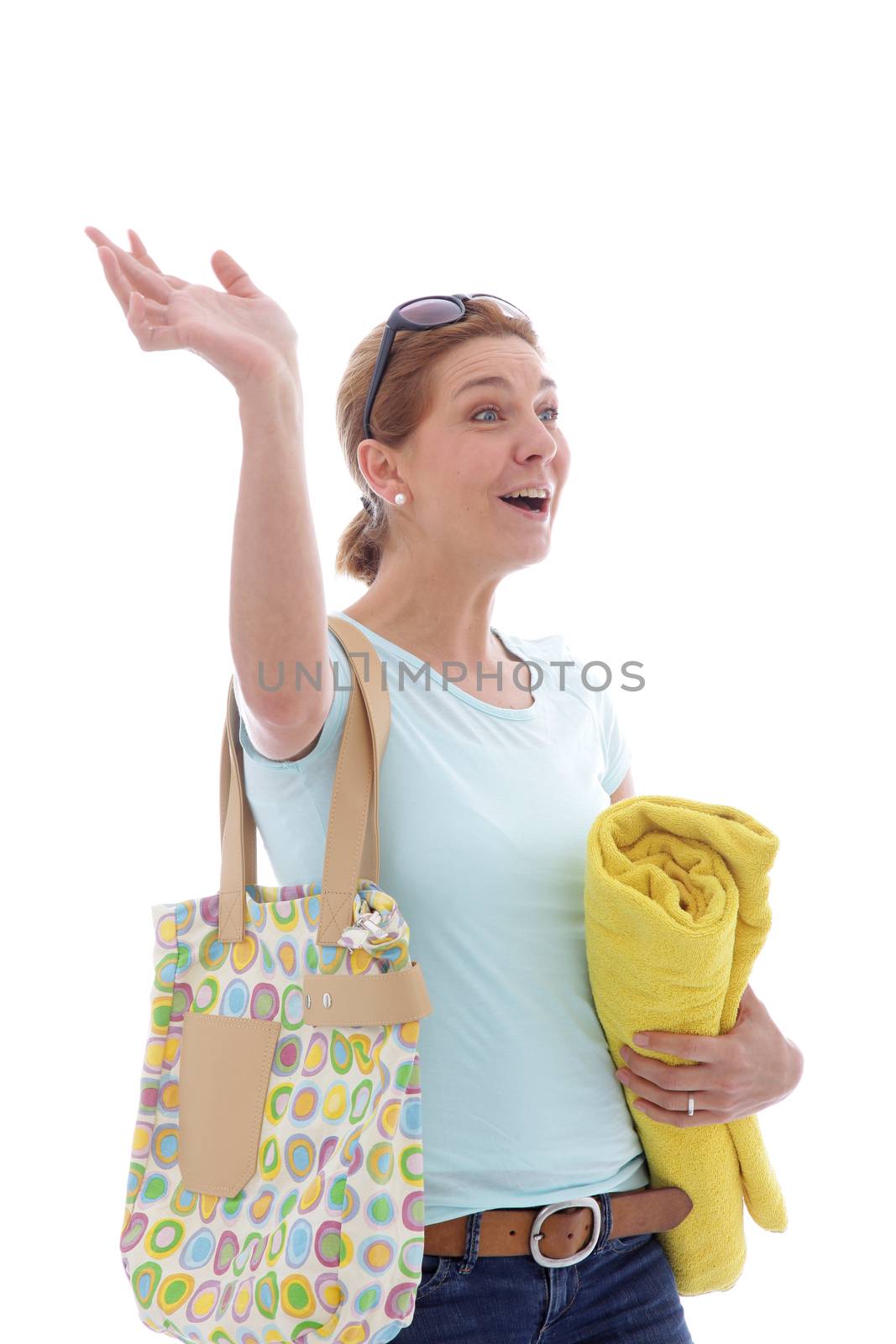 Hailing woman in glasses goes to the beach with bag and towel