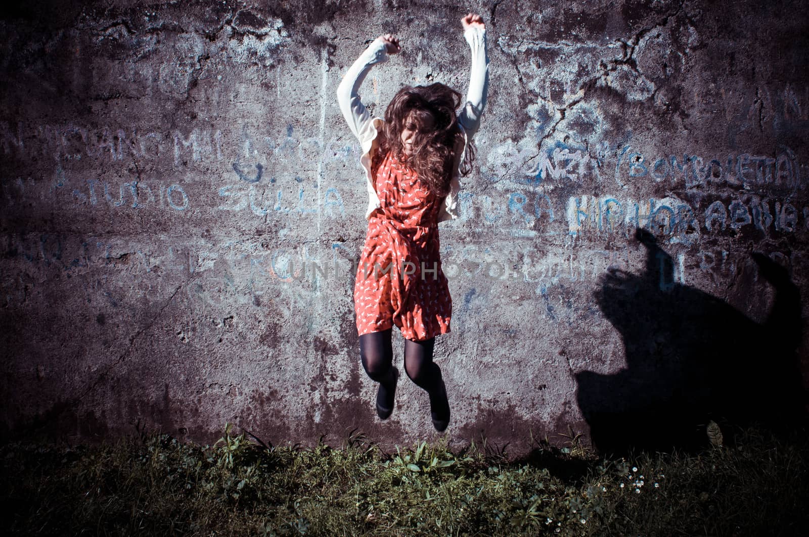 happy eastern vintage hipster woman jumping in the park