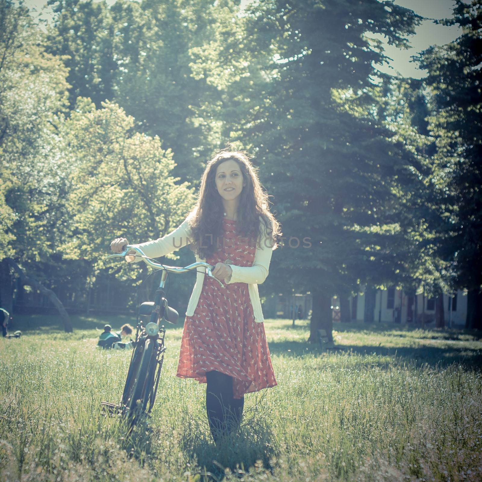 vintage eastern hipster woman with bike in the park