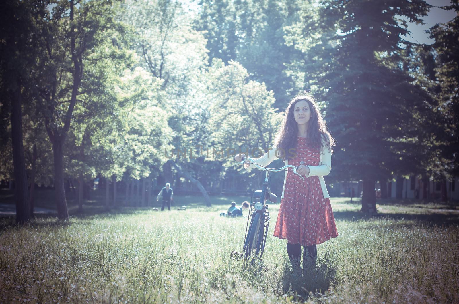 vintage eastern hipster woman with bike in the park
