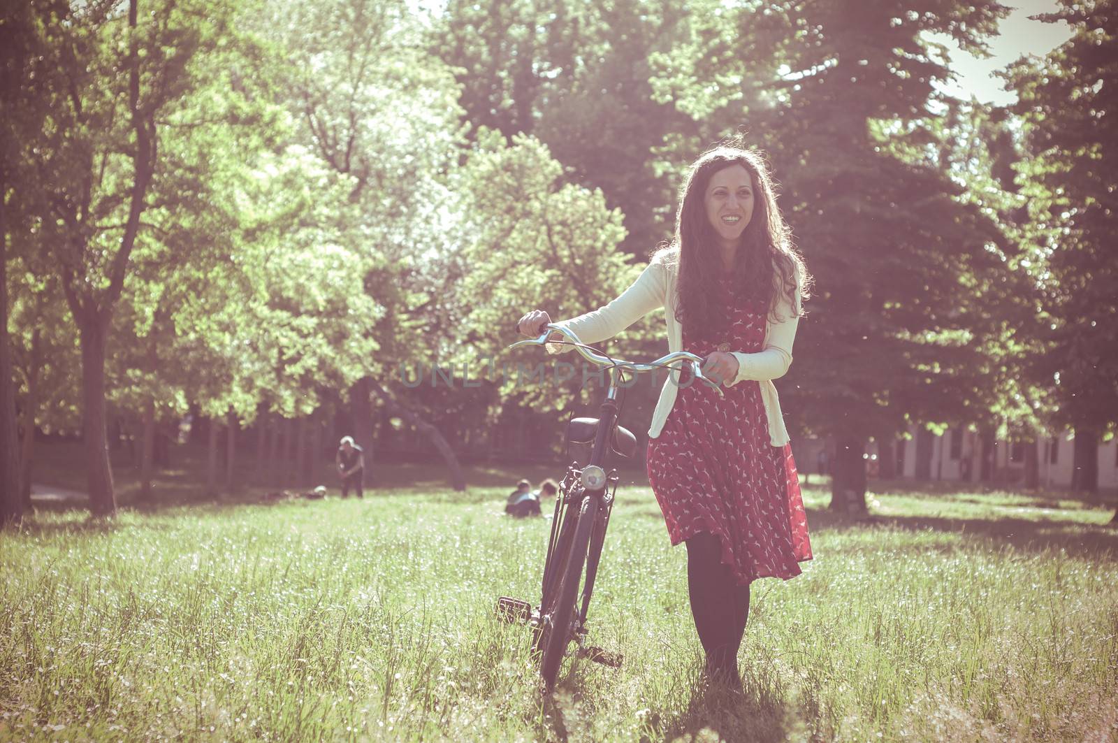 vintage eastern hipster woman with bike in the park