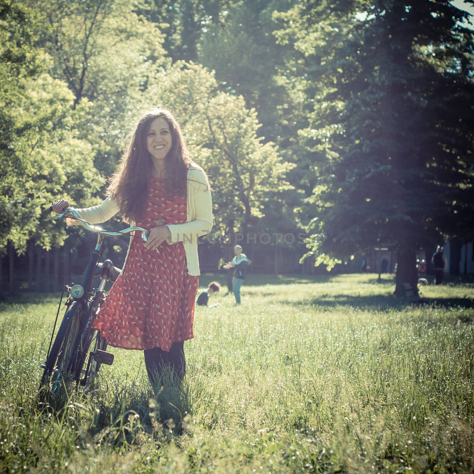 vintage eastern hipster woman with bike in the park