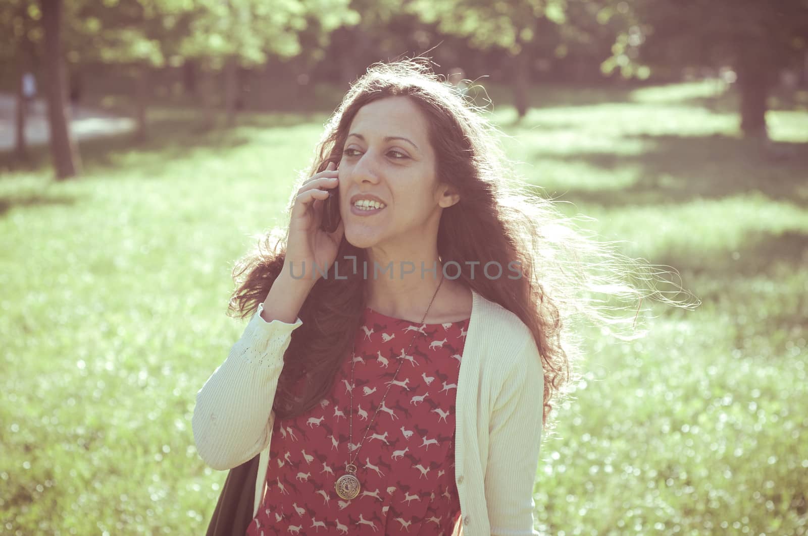 hipster vintage woman on the phone at the park