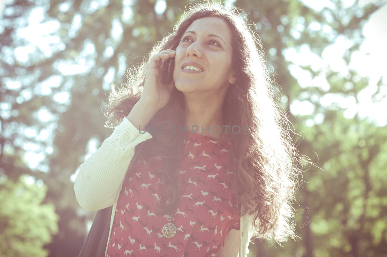 hipster vintage woman on the phone at the park