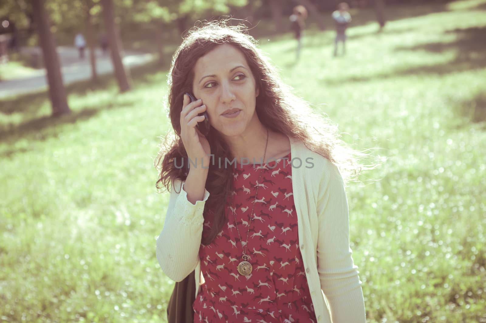 hipster vintage woman on the phone at the park