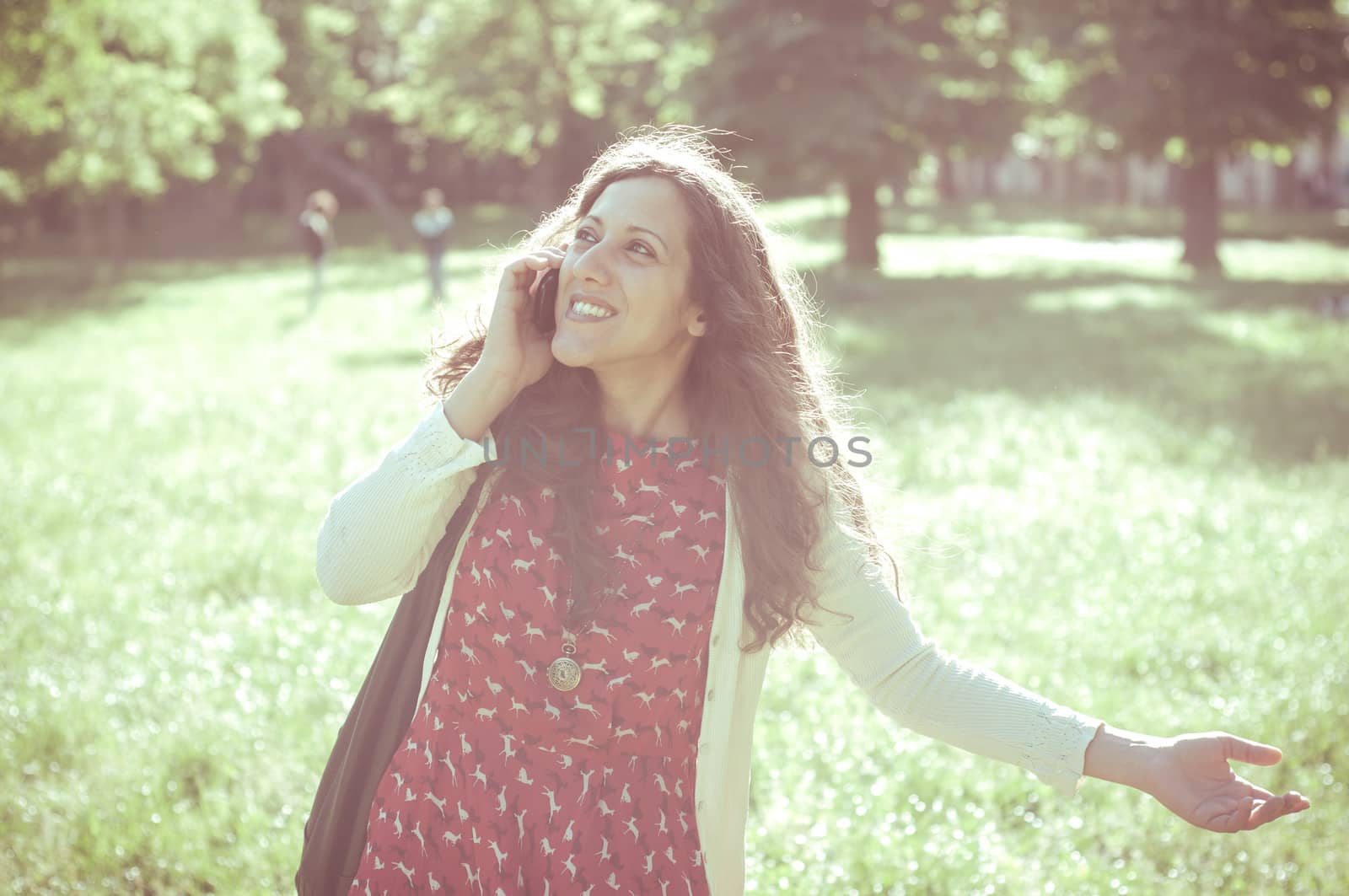 hipster vintage woman on the phone at the park